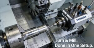 Close-up interior view of a high-end CNC turn-mill center machining a complex metal part in a single setup, showcasing the integration of turning and milling operations.